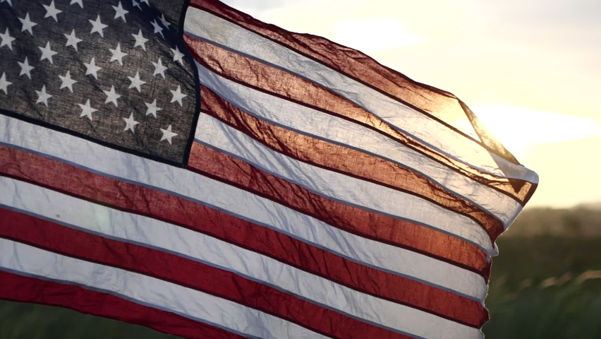 American USA flag waving in the wind against sunset in nature outdoor background. Concept of 4th of July, Memorial Day, Independence Day, Veterans Day, American Celebration, Patriots, Labor, President | Shutterstock HD Video #1091208241