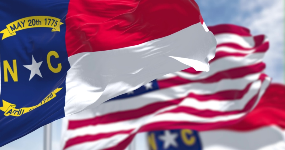 The North Carolina state flag waving along with the national flag of the United States of America. Seamless loop in slow motion. North Carolina is a state in the Southeastern region of the US | Shutterstock HD Video #1091217297