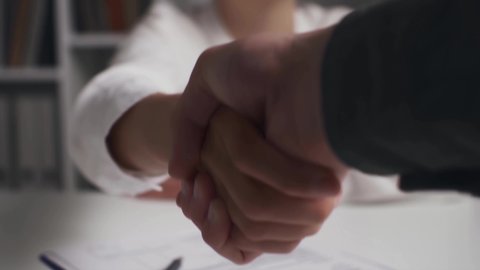 Closeup handshake, insurance agent girl shaking hands with client symbol concept of successful deal, parties succeeded, shaking hands with each other, shaking hands as a symbol of greeting
