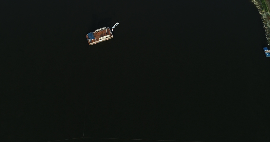 Aerial view of a passenger ferry boat crossing Drava river, Osijek, Croatia.