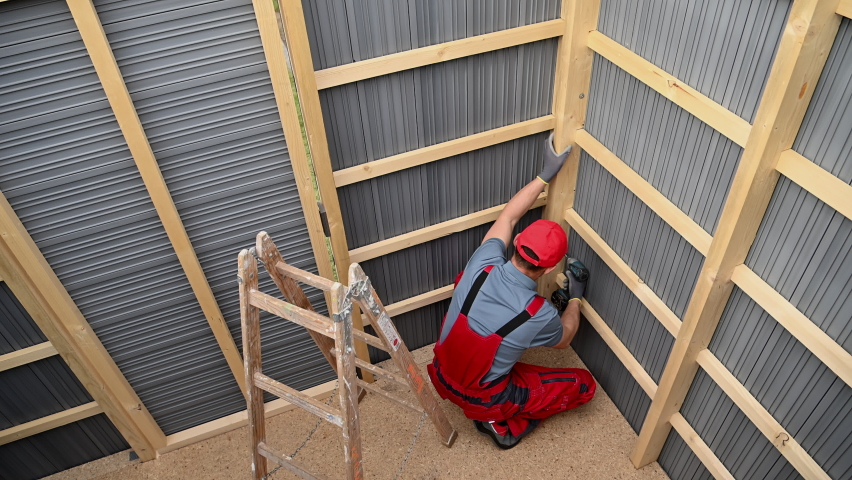 Wood Skeleton Frame and Composite Walls Garden Storage Shed Building by Caucasian Professional Shed Builder. Backyard Garden Tools Storage.