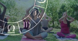 Circle of zodiac signs over diverse group of people practicing yoga. Horoscope, yoga meditation concept digitally generated video.