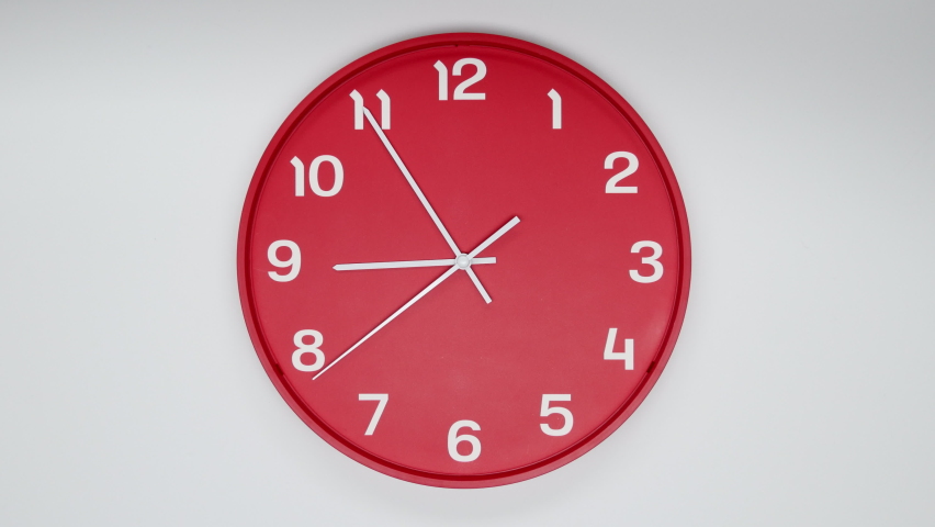A Red Wall Clock With The Time Of 9.00 Am Or Pm. A White Hands Of The Clock, The Concept Of Time. 4k. ProRes. Royalty-Free Stock Footage #1091228133