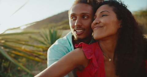 Beautiful romantic young couple in love, happy diverse couple enjoying sunset at the beach Video de stock