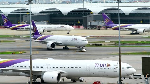 BANGKOK-JUNE 12, 2022: View docked away flights in Suvarnabhumi Airport. Suvarnabhumi Airport is one of two international airports serving Bangkok, Thailand.