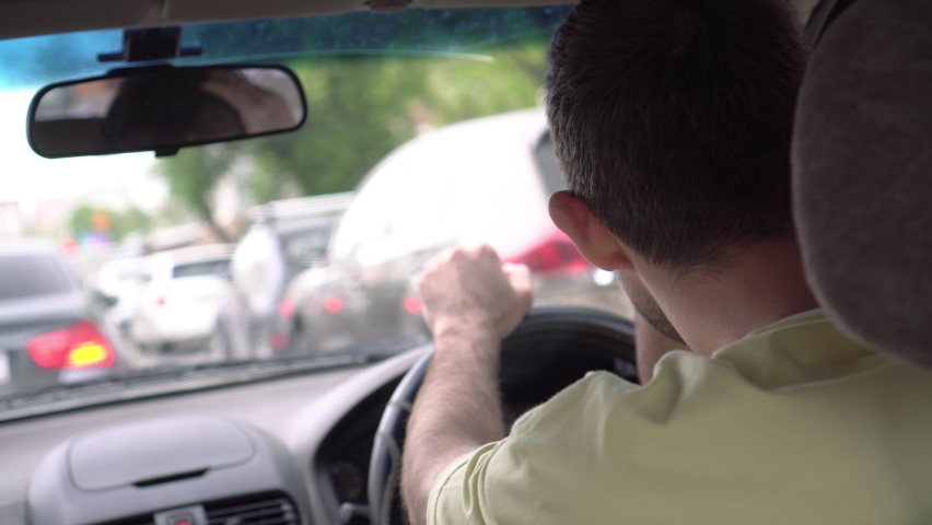 Angry driver in a car in a traffic jam. Unhappy man in a traffic jam Royalty-Free Stock Footage #1091237823