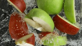 Super Slow Motion Shot of Red and Green Apple Cuts Falling and Splashing into Water at 1000fps. - Powered by Shutterstock - Get 15% off with code: PIKWIZARD15