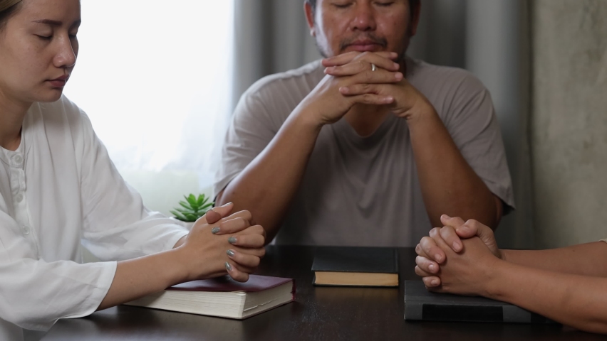 Asian Christian groups sitting within the Church Catholic prayed for blessings from God. A pale sun shone in a place of worship.Religious concepts. Royalty-Free Stock Footage #1091245201