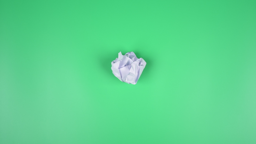 Stop motion VDO, paper ball unwrapping on green background. Royalty-Free Stock Footage #1091246729