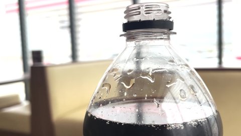 cola carbonated drink. American drink in a plastic bottle in a fast food cafe at a gas station lifestyle. cola lemonade drink. drink with ice in cafe