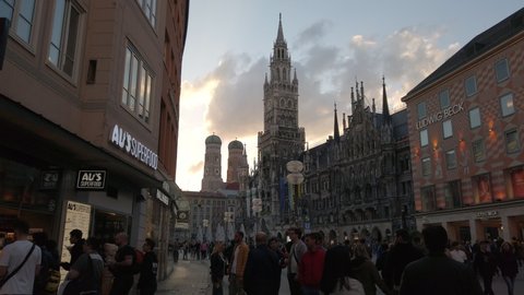 Munich, Germany - May 30, 2022: 4k time lapse POV footage approaching Marienplatz with view of town hall and Frauenkirche at dusk