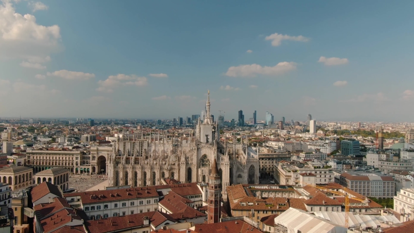 Aerial Reveal Shot Of Distant Milan Skyline and Milan Cathedral Duomo Di Milano At Sunset Royalty-Free Stock Footage #1091252265