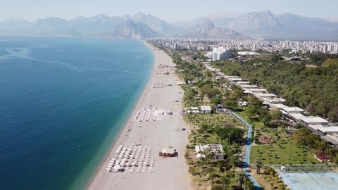 Awesome aerial view of Konyaalti Beach and Park in Antalya, Turkey. Drone flying over the beach. Konyaalti Beach is a popular tourist attraction in Turkey.