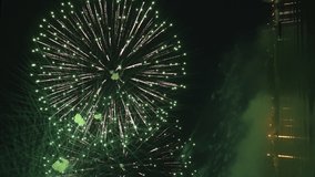 Vertical 4k footage of beautiful Fireworks on Deep Black Background Sky on Fireworks festival from sail yacht over night city lights in summer river night trip. High quality 4k raw video - Powered by Shutterstock - Get 15% off with code: PIKWIZARD15