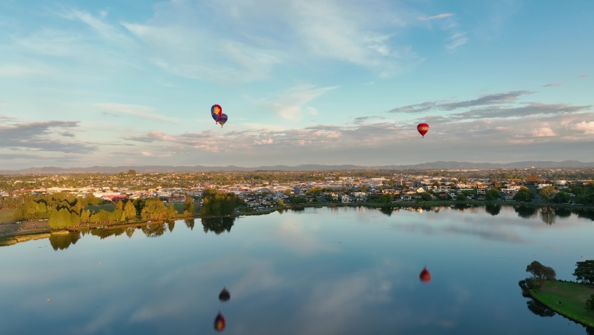 Hot air balloons taking off and heading over Hamilton City in New Zealand for Balloon festival.