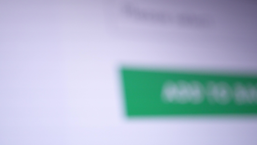 Mouse cursor clicks on the "Add To Bag" button. Macro shot close up of design UI, mock-up. Screen of a monitor or gadget showing a button for an online application or website for shopping.