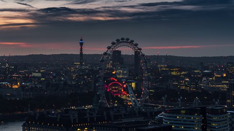 London, Great Britain - circa 2022 - London Eye BT Tower at dusk sawn, evening sunset, Establishing Aerial View Shot of London UK, United Kingdom, stunning light