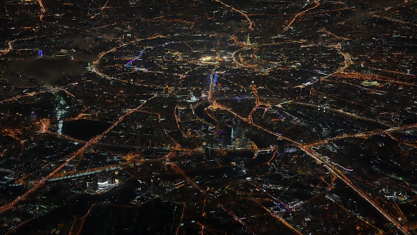 Flying high over night city center downtown 