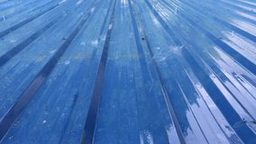 Video clip of tropical rain in blue corrugated roof with sound