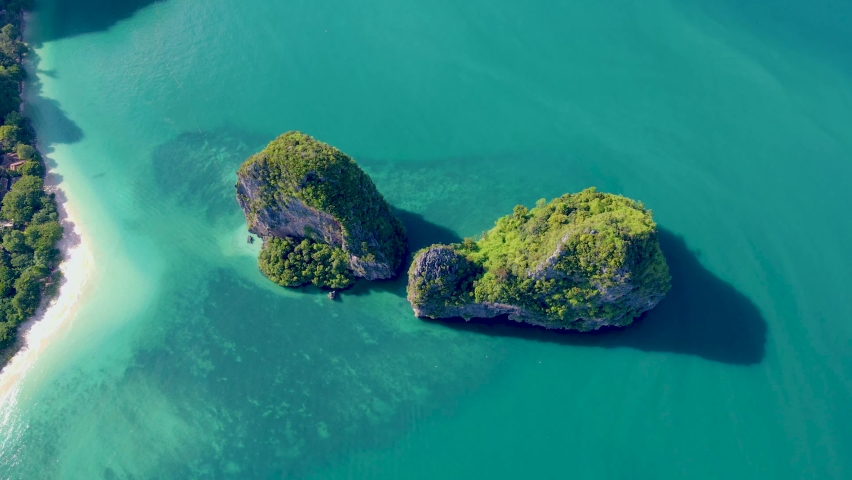 Railay Beach Krabi Thailand, the tropical beach of Railay Krabi, Drone aerial view of Panoramic view of idyllic Railay Beach in Thailand with a huge limestone rocks from above with drone | Shutterstock HD Video #1091273613