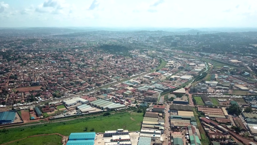 Aerial view of densely populated area and industrial zone in Kampala, Uganda. Royalty-Free Stock Footage #1091275003