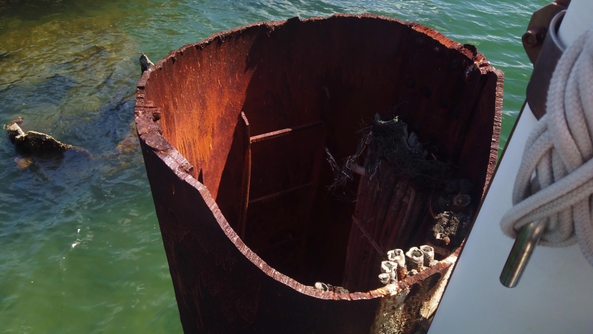 Close-up panning shot of the ruined smoke stack from the sunken World War II battleship USS Arizona at Pearl Harbor on the island of O