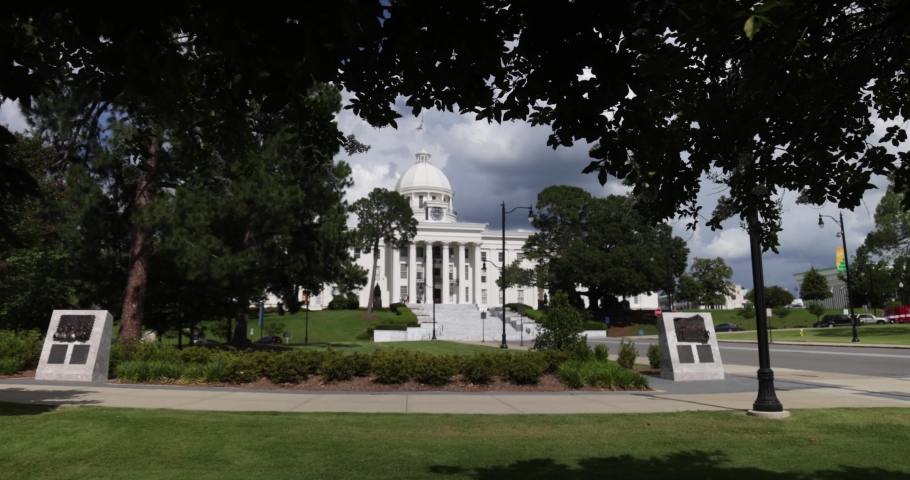 Alabama state capitol in Montgomery with gimbal video walking through trees in slow motion.