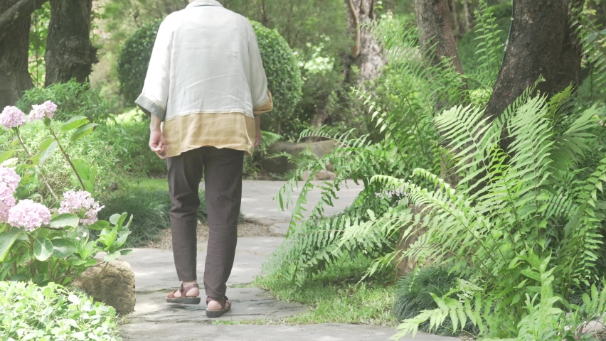 old elderly elder senior woman resting relaxing walking in garden