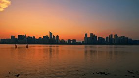 Panoramic skyline and modern commercial buildings with river in Hangzhou at sunset, China. day to night. 4k time lapse video.