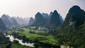 Aerial footage of beautiful mountain and river with village natural landscape in Guilin, China. Famous travel destination in China.