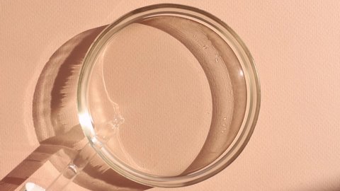 pipette drops fall into a petri dish with sunlight