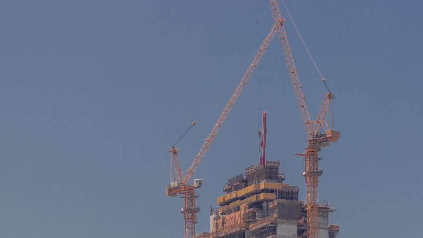 Skyscraper under construction with cranes timelapse. Building of new multi-storey tall tower with builders working on top | Shutterstock HD Video #1091283177