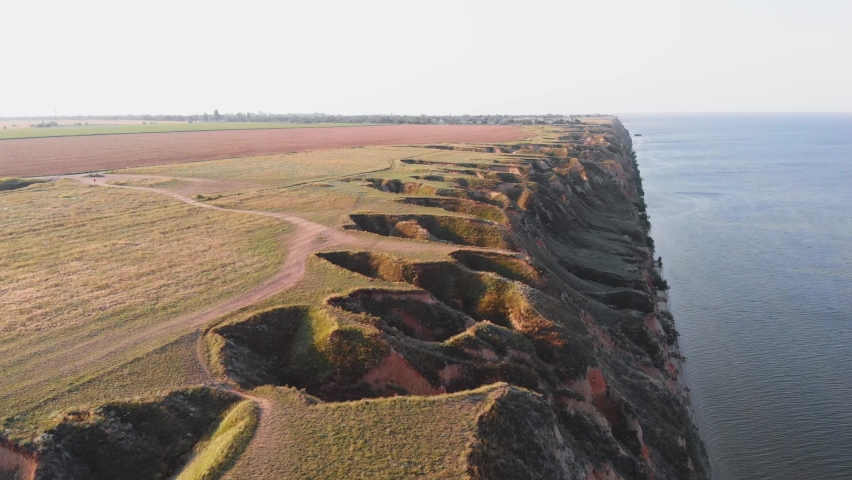 View of the mountains by the sea. Mountain landscape by the sea. Yellowish-red rocks in a canyon near the Black Sea