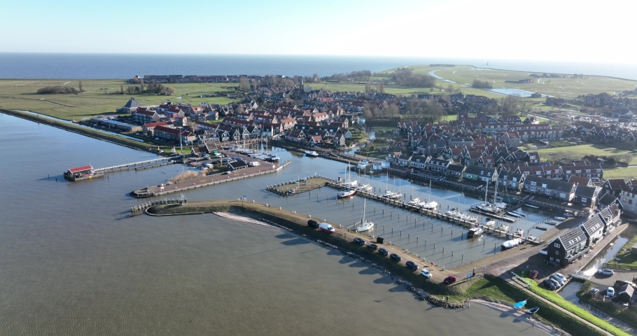 Peninsula Marken in the municipality of Waterland harbour. Old dutch historic fishing village in the Markermeer. European dutch culture, old wooden houses. Touristic attraction. Royalty-Free Stock Footage #1091291049