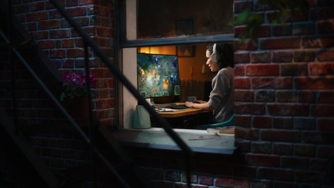 Cheerful Female Gamer Playing Online Video Game on Personal Computer. Professional Woman Player Enjoying Fantasy RPG. Real Role Playing Character Casting Magic Spells, Destroying Enemies. Window View