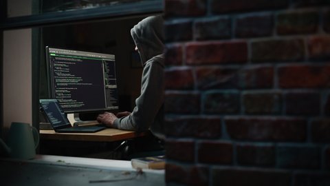 Single-Minded Professional Programmer Obsessively Writing a Code on His Desktop Computer, Late at Night. IT Specialist Ethical Hacker Working on Computer, Finding Software Vulnerabilities