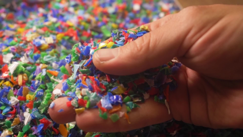 Microplastics in hands. colorful plastic fragments or particles, toxic chemicals, environment, water pollution. pieces of microplastic in the world's oceans. plastic recycling concept | Shutterstock HD Video #1091292985