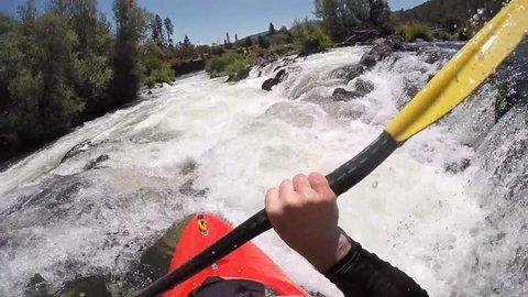 Whitewater kayak running class IV Powerhouse Rapid on the Rogue River in southern Oregon. POV
