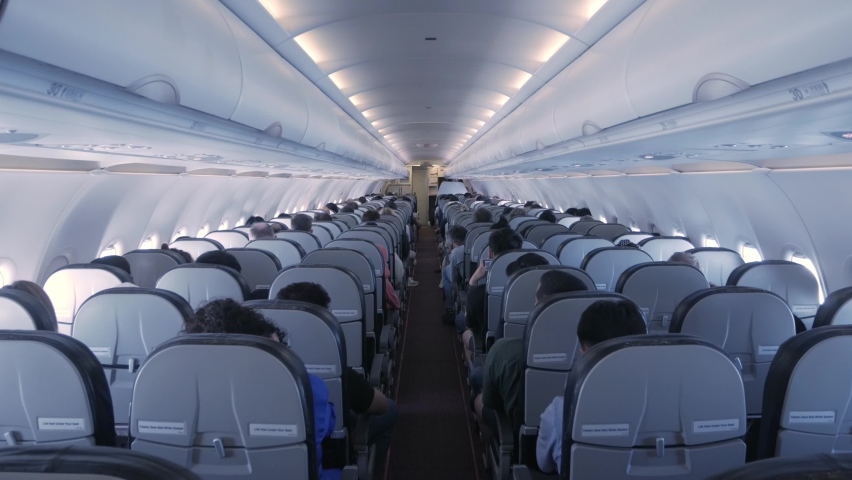 the aisle pathway inside plane cabin with passenger Royalty-Free Stock Footage #1091298131
