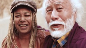 Happy multiethnic senior couple doing selfie or video call with mobile phone outdoor - Powered by Shutterstock - Get 15% off with code: PIKWIZARD15