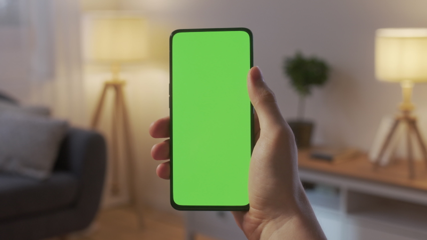 Point of View of Man at Phone with Green Screen for Copy Space. Chromakey Mock Up Without Tracking Markers. Close Up. Boy is Surfing Content With Touching Swiping Up and Tap Center. Royalty-Free Stock Footage #1091304985