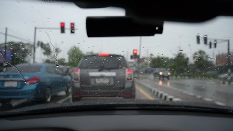 slow motion scene, drive car in rainy day, windshield wiper clean rain drop on windscreen