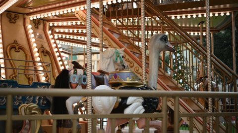 Colorful Carousel Attraction Ride With Wooden Horses.