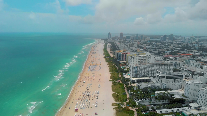 MiaMiami South Beach sunrise with lifeguard tower and coastline with colorful cloud and blue sky, South Beach, Miami Beach. Florida South Beach sunrise with lifeguard tower and coastline