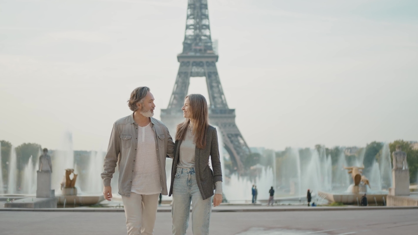 Happy senior couple in Paris. Senior woman and man spending time together at the eiffel tower. Concept about european tourism and landmarks