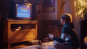Nostalgic Childhood Concept: Young Boy Playing Old-School Arcade Space Shooter Video Game on a Retro TV Set at Home in His Room with Period-Correct Interior. Successful Kid Passes the Level and Wins.