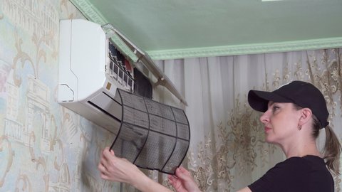 Maintenance of air conditioning installed in apartment. Inspection and cleaning of filter. 4k video.
