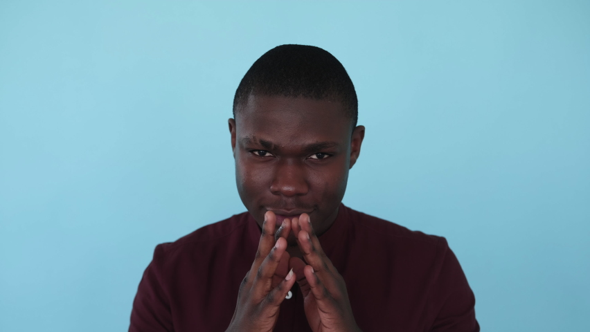 Tricky man. Evil plan. Prank scheme. Boomerang animation. Devious sneaky sly guy steepling fingers isolated on blue background GIF loop motion.