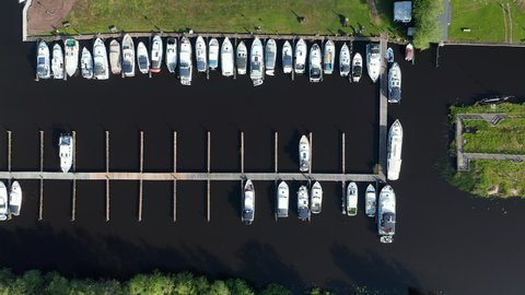 Rows Of Sailboats Docked In The Polder In Waterstaete Ossenzijl, Netherlands. - Drone Overhead Shot

