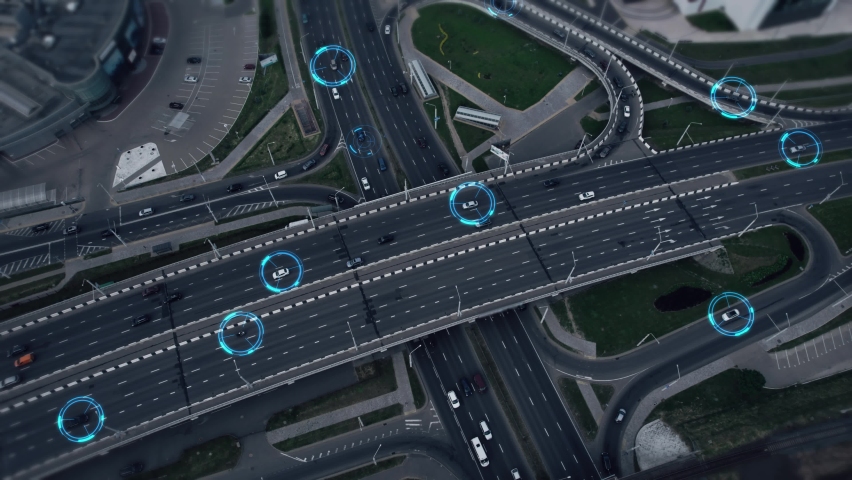 Concept of smart cars and transportation of the future. Automated robotic system remotely controls self-driving cars in the city. Artificial Intelligence Digitalizes and Analyzes Roads. Aerial view.  Royalty-Free Stock Footage #1091331259